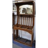 An early 20th Century Scottish Arts & Crafts oak hall stand, of tapered form with central mirror