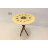 A MID 20th CENTURY PIREO FORNASETTI OCCASIONAL TABLE, having white lacquered top, decorated with