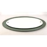 A 1960s ELLIPTICAL ITALIAN MIRROR, manufactured by Cristal Arte, with tinted green mirrored glass