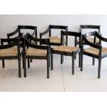 A SET OF SEVEN 1960s CARIMATE CHAIRS DESIGNED BY VICO MAGISTRETTI, with rush seats and black