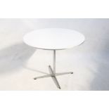 A CIRCULAR DINING TABLE DESIGNED BY PIET HEIN, MANUFACTURED BY FRITZ HANSEN, DENMARK, with white