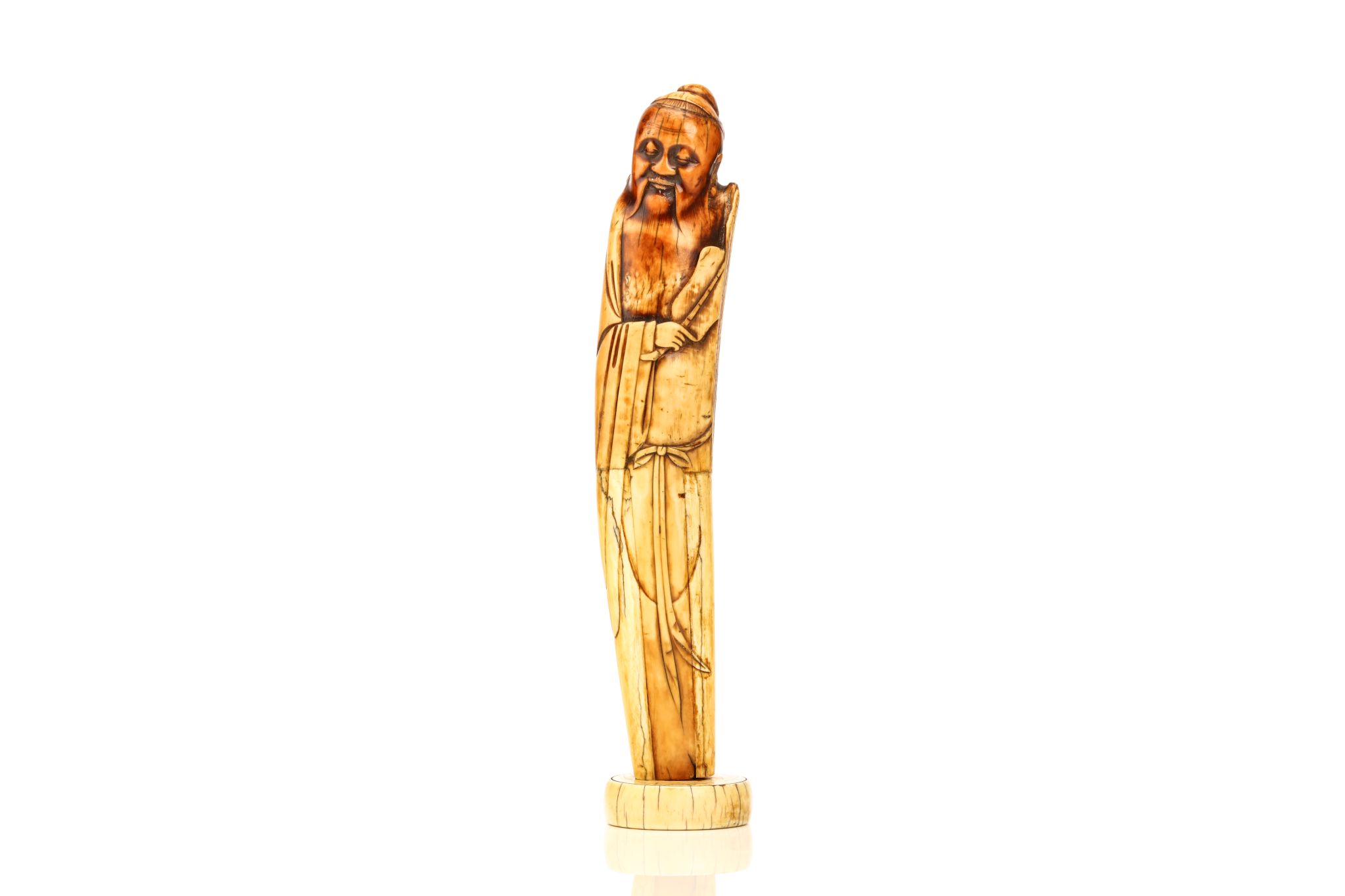 A CHINESE IVORY CARVING OF ZHONGLI QUAN. Ming Dynasty. Standing in flowing robes tied at the