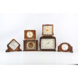 SIX EARLY 20TH CENTURY MANTLE CLOCKS the first of square form by 'Garrard' with silvered dial and