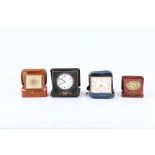 FOUR VARIOUS TRAVELLING TIMEPIECES IN LEATHER CASES including a Smiths alarm clock with seven jewels