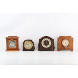 FOUR EARLY 20TH CENTURY SMITHS MANTLE CLOCKS comprising two in bakelite, one oak cased, the last