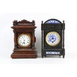 AN AESTHETIC PERIOD EBONISED AND PORCELAIN MOUNTED MANTEL CLOCK TOGETHER WITH ANOTHER SIMILAR both