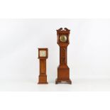 TWO EARLY 20TH CENTURY OAK CASED MINIATURE LONGCASE CLOCKS the larger inlaid with a vase with flower