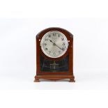 EARLY 20TH CENTURY MAHOGANY BULLE ELECTRIC CLOCK the arched case with glazed front, silvered dial