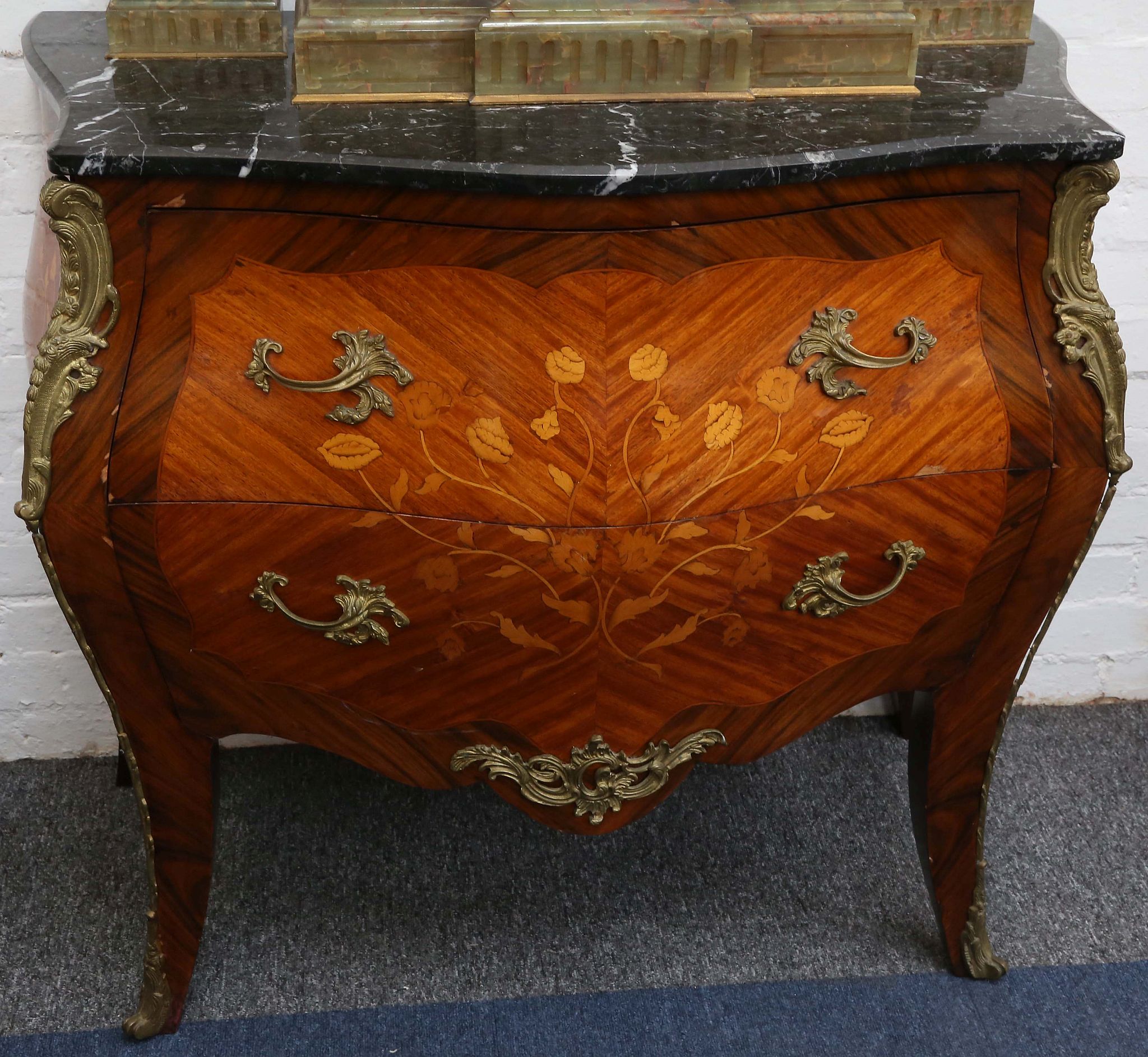 A Louis XV design, marquetry inlaid kingwood bombe commode, with marble top over two drawers,