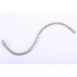 A diamond line bracelet, The line of brilliant-cut diamonds, highlighted centrally by a slightly