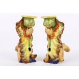 A pair of 'Grotesque' French faience candlesticks, early 20th Century, both modelled as kneeling