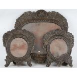 A garniture of 19th Century French mirrors, having repousse brass frames, the two side mirrors