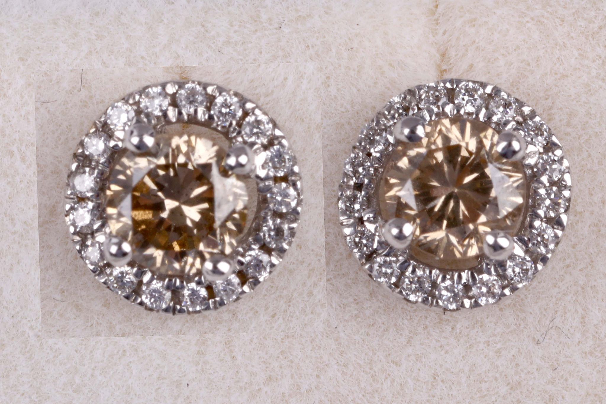 A pair of coloured diamond and diamond earstuds, Each brilliant-cut diamond of brown tint,