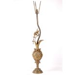 A 20th Century brass table lamp in the form of a cast ewer with putti at play, scrolls and masks,