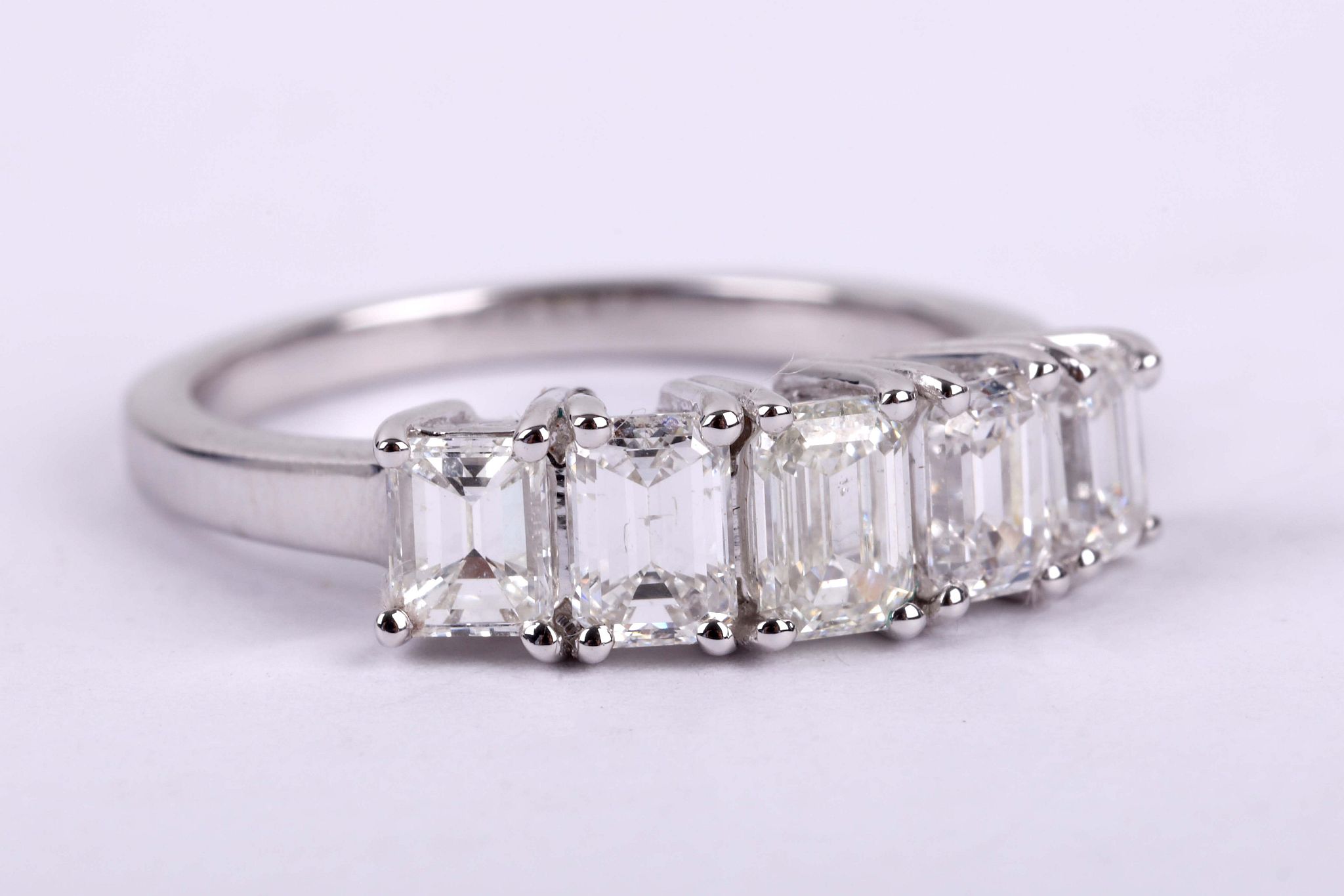 A diamond five-stone ring, The graduated line of baguette-cut diamonds, the largest to the centre,