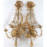 A highly ornate gilded wood, three branch French Empire style and rococo taste wall sconces,