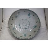 A South East Asian, probably Vietnamese, earthenware celadon dish with painted and incised