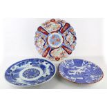 Three Meiji period Japanese porcelain chargers, one lobed example in Imari palette, a blue and white