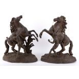 A pair of spelter Marley horses with attendants on naturalistic bases, 40cm high.