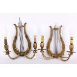 A pair of early 20th Century French Empire style ormolu gilded metal, twin-handled wall sconces (