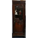 A 19th Century Normandy oak armoire section enclosed by a carved, part glazed door, on stile feet,