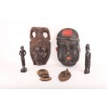 Six wooden tribal masks and figures, 19cm - 38cm.