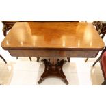 An early 19th Century mahogany fold over tea table, supported on tapered fluted central column,