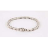 A 14k white gold and diamond line bracelet, set with 6.86cts of princess cut stones.