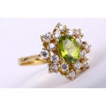 A peridot cluster ring              The oval-cut peridot, within a cluster of brilliant-cut cubic