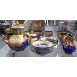 A suite of 20th Century Bohemian gilt overlay blue glass, comprising teapot, sugar bowl and cream