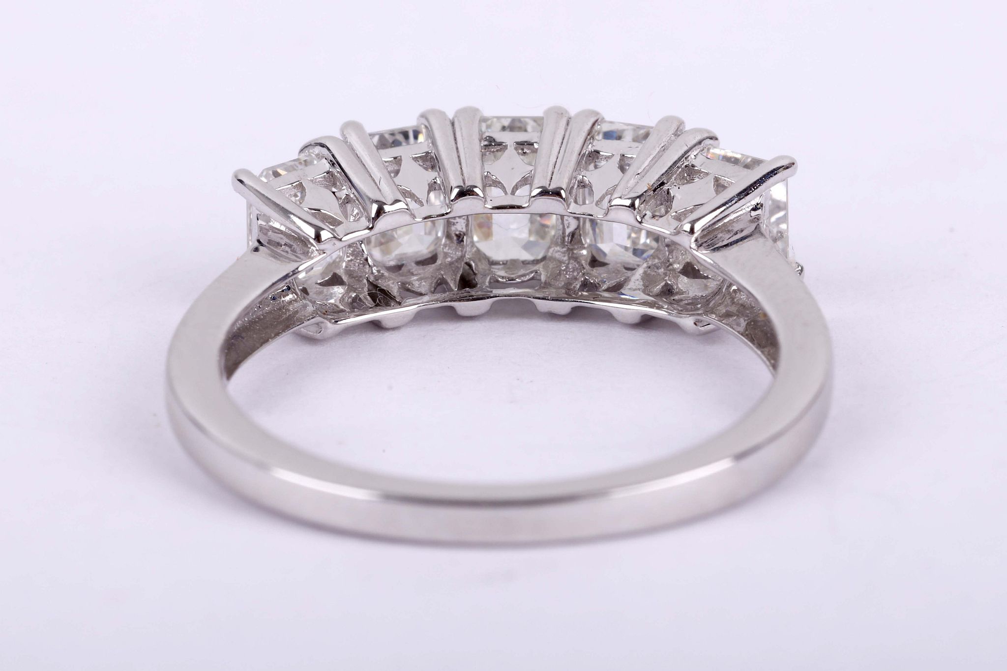A diamond five-stone ring, The graduated line of baguette-cut diamonds, the largest to the centre, - Image 2 of 2