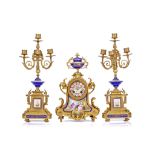 A LATE 19TH CENTURY FRENCH GILT BRONZE AND SEVRES STYLE PORCELAIN CLOCK GARNITURE the arched clock