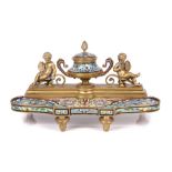 A LATE 19TH CENTURY FRENCH GILT BRONZE AND CHAMPLEVE ENAMEL FIGURAL INKSTAND IN THE MANNER OF