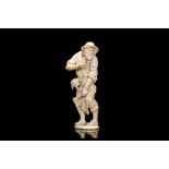 AN 18TH CENTURY GERMAN IVORY FIGURE OF A PAINTER the standing figure in ragged clothes and hat,
