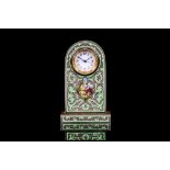 A SMALL LATE 19TH CENTURY VIENNESE SILVERED AND ENAMELLED DESK / BOUDOIR CLOCK of arched form, the