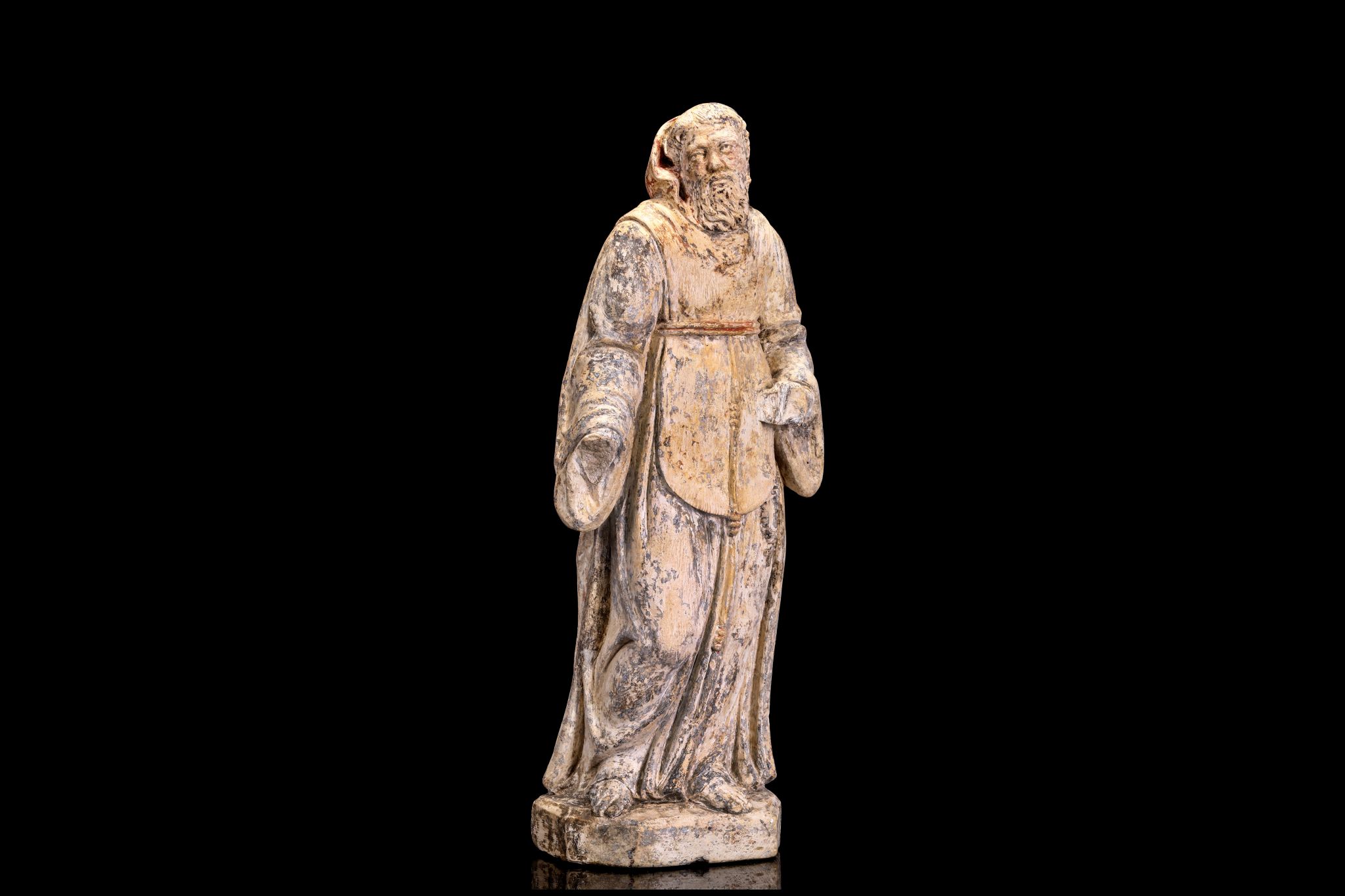 A 17TH CENTURY NORTH EUROPEAN CARVED STONE FIGURE OF ST FRANCIS OF ASSISI  the standing figure