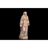 A 17TH CENTURY NORTH EUROPEAN CARVED STONE FIGURE OF ST FRANCIS OF ASSISI  the standing figure