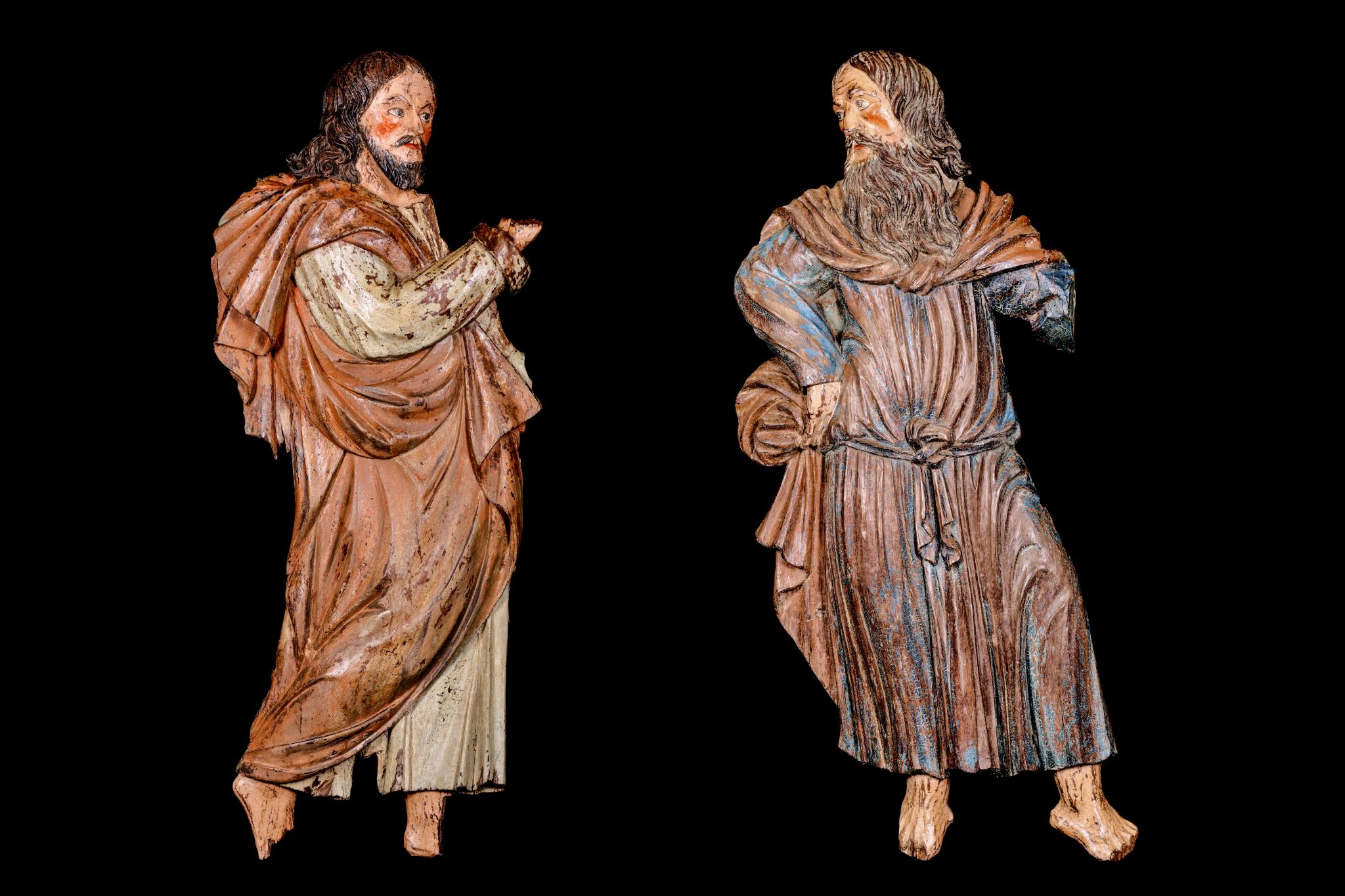 A LARGE PAIR OF 16TH CENTURY SOUTH GERMAN CARVED WOOD AND POLYCHROME DECORATED RELIEFS OF SAINTS the