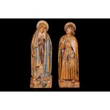 A PAIR OF EARLY 16TH CENTURY GERMAN (FRANCONIAN) CARVED AND POLYCHROME DECORATED LIMEWOOD FIGURES OF