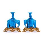 A PAIR OF CHINESE QING DYNASTY TURQUOISE GLAZED ELEPHANT CANDLESTICKS ON GILT BRONZE BASES each