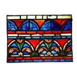 A 19TH CENTURY GOTHIC STYLE PANEL OF STAINED / LEADED GLASS of rectangular form, with a border of
