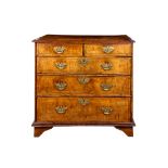 A WILLIAM AND MARY WALNUT AND FEATHER BANDED CHEST OF DRAWERS CIRCA 1700 the top with circular