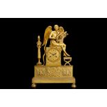 AN EARLY 19TH CENTURY FRENCH EMPIRE PERIOD GILT BRONZE FIGURAL MANTEL CLOCK the plinth case