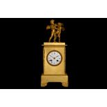 AN EARLY 19TH CENTURY FRENCH EMPIRE PERIOD GILT BRONZE FIGURAL MANTEL CLOCK the plinth case