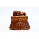 A 19TH CENTURY CARVED ROOTWOOD SNUFF BOX the box with hinged lid surmounted by a carved model of a