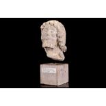 A 13TH / 14TH CENTURY FRENCH GOTHIC CARVED LIMESTONE HEAD OF A MAN with finely carved strands and