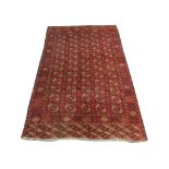 An early 20th Century Turkoman Bokhara carpet, 2.97m x 1.96m, condition rating B/C.