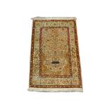 A mid 20th Century Turkish silk and metal thread Hereke rug with inscription, 1.13m x 0.75m,