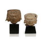 TWO PRE-COLUMBIAN SMILING HEADS, VERA CRUZ Each wearing headdresses with large disc earrings, with