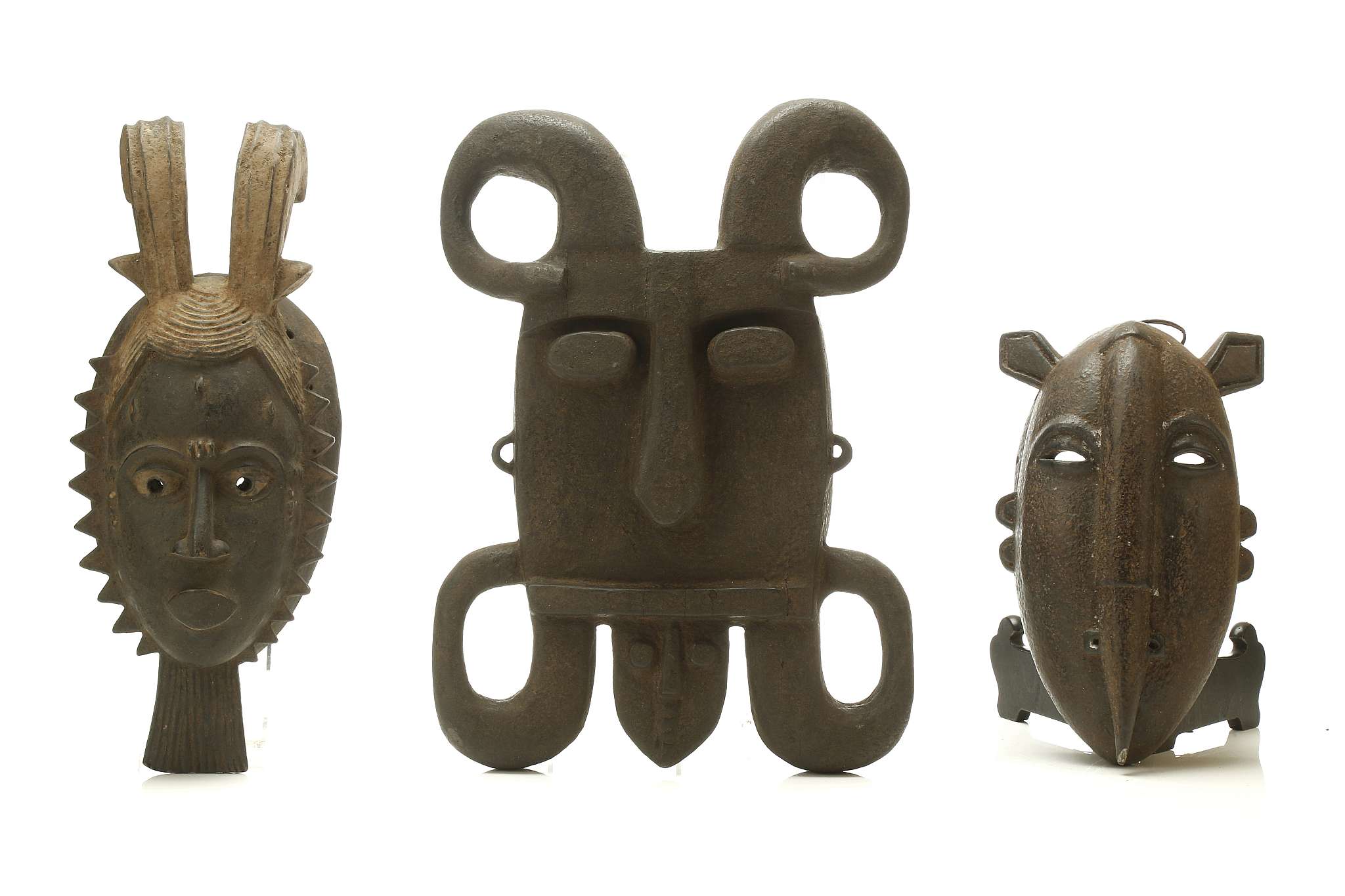 AN WOODEN IJAW MASK, NIGERIA, AND TWO WOODEN MASKS, IVORY COAST The Ijaw mask square in form with